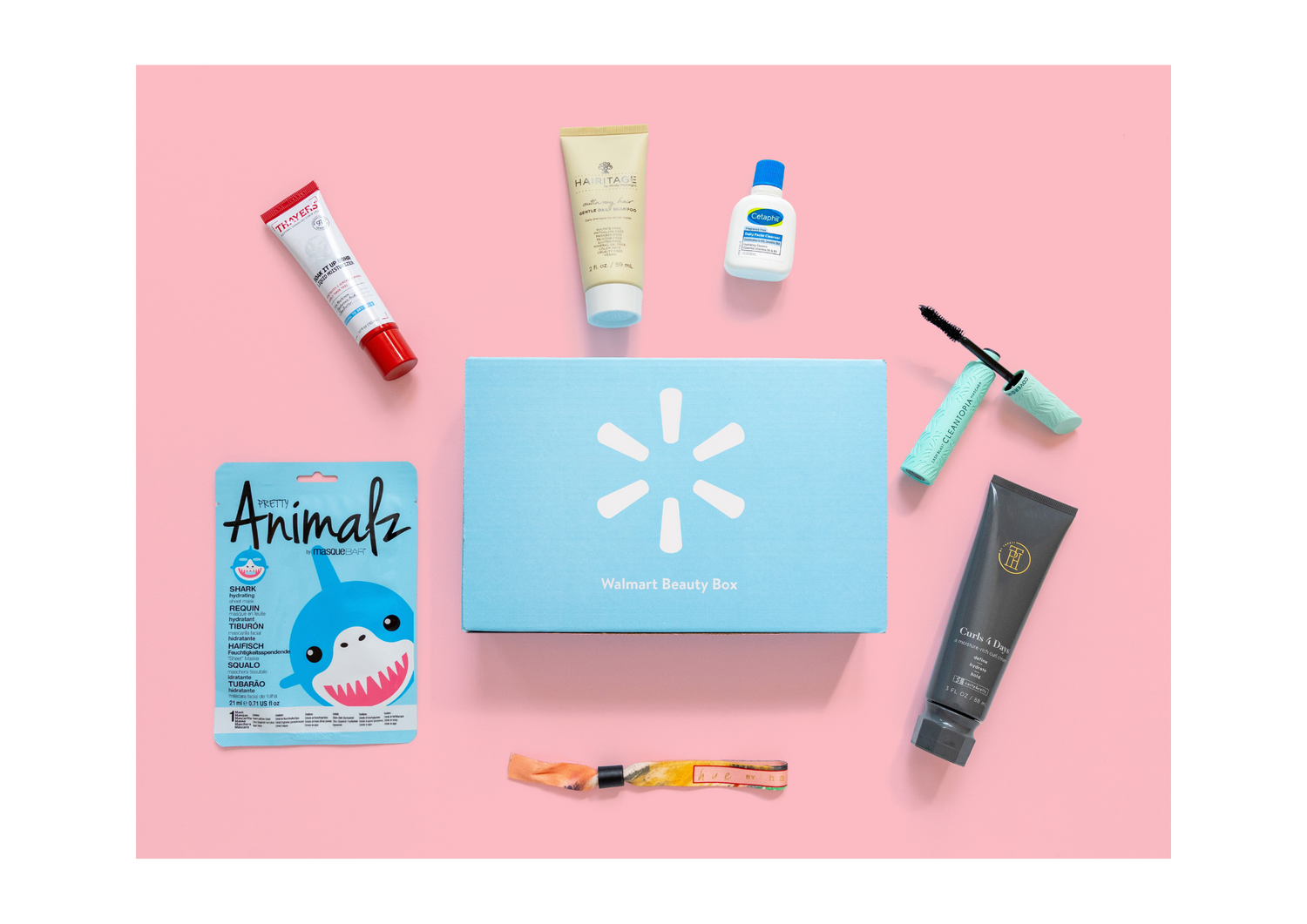 Walmart Beauty Box on a pink background surrounded by the following products: Hue by Hayley Scented Bracelet, Masque Bar Pretty Animals Shark Sheet Mask, Thayers Soak It Up Moisturizer, TPH by Taraji Curls 4 Days Curl Defining Cream, Covergirl Lash Blast Cleantopia Mascara, Hairitage Outta My Hair Gentle Daily Shampoo, and Cetaphil Daily Facial Cleanser.